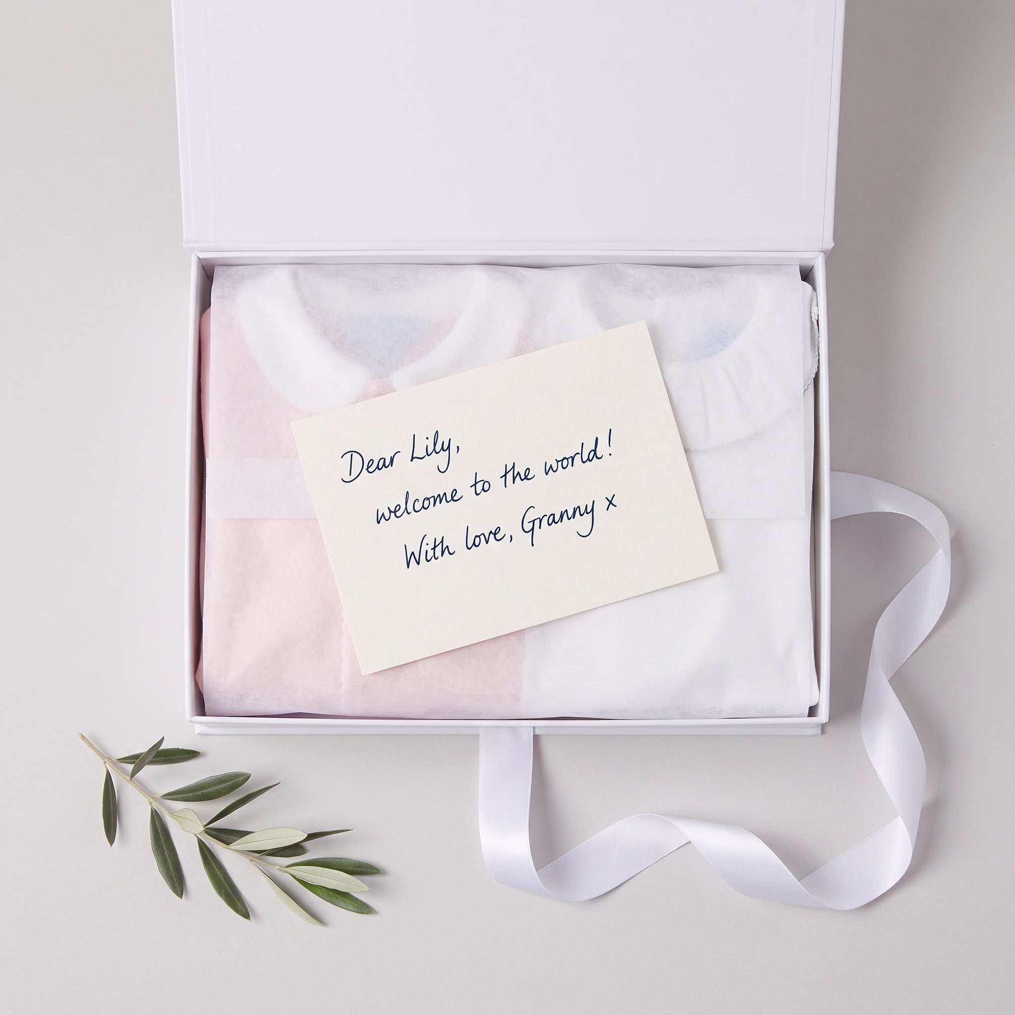 Club Cinq gift box with a handwritten message card: Dear Lily, welcome to the world! With love, Granny